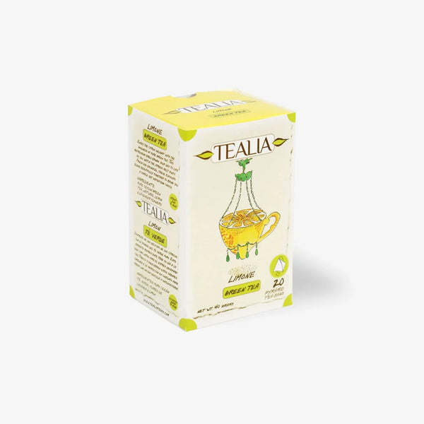 Box of lemon green tea with illustrated cup and lemon slices on white background