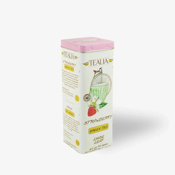 Strawberry green tea loose leaf tin with illustrated fruit and glass on white background